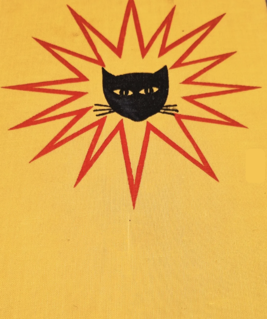 Black cat head bursting from a red star, screen printed on cloth